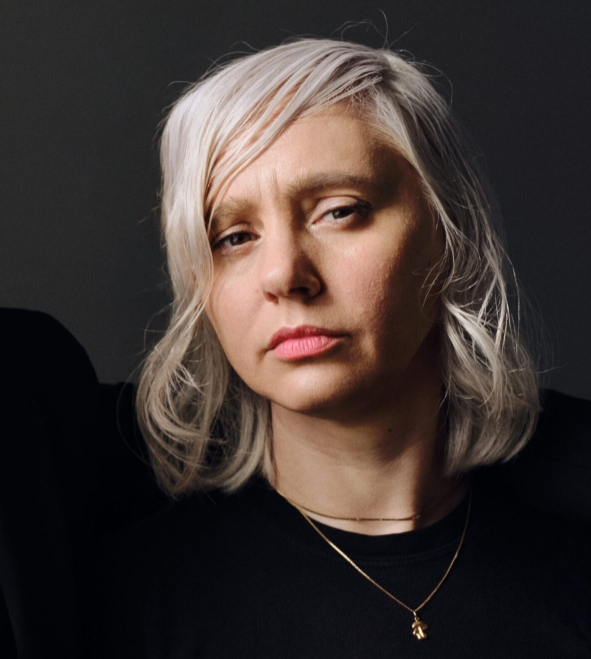 Natalia Yanchak, wearing black, against a black background